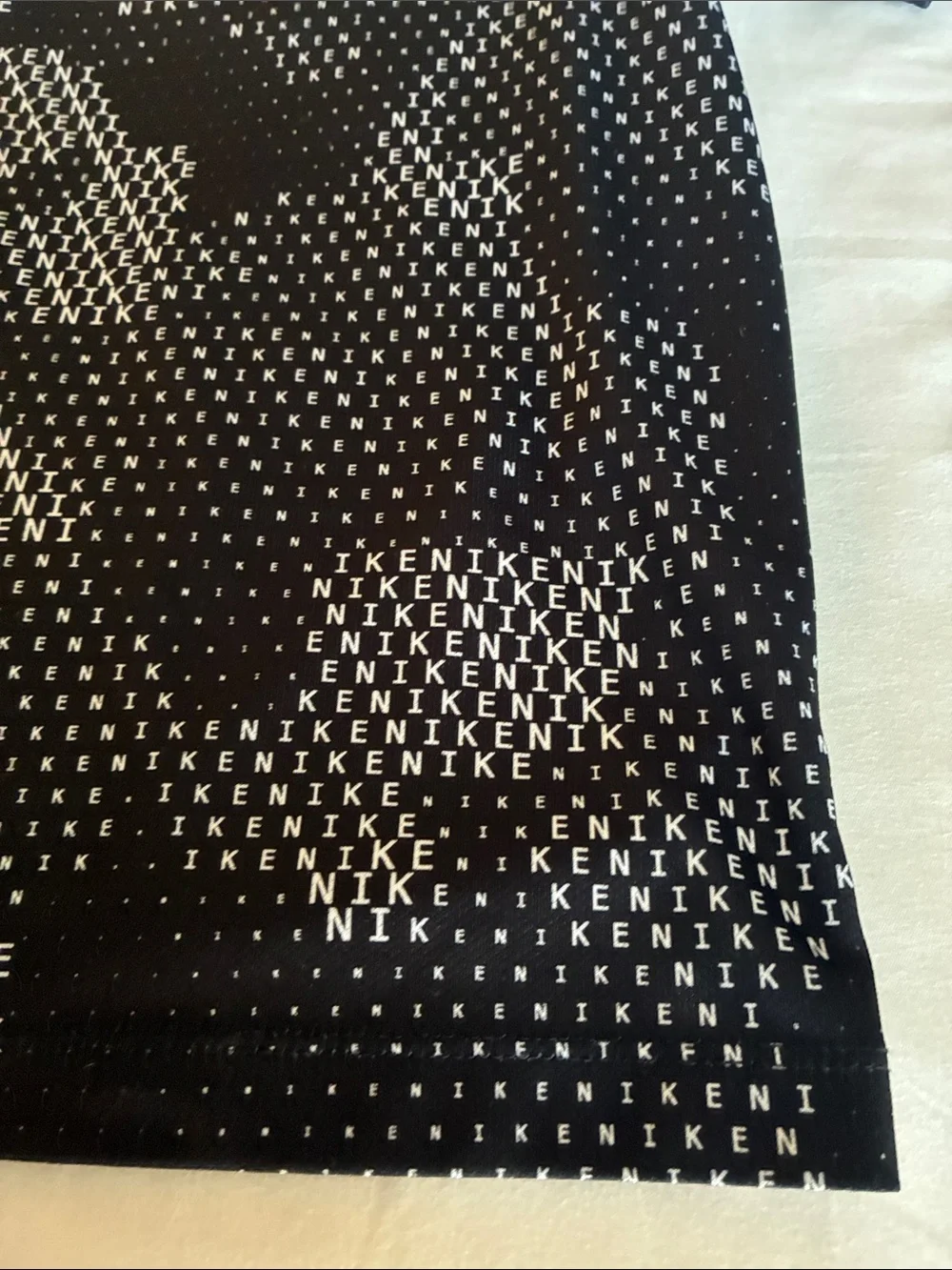 Nike Black Tee with White Micro-Text and Swoosh